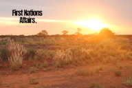 Sunset over an Australian outback landscape with red earth, native grasses, and the text “First Nations Affairs” in bold black font.